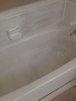 New surface being applied to a bathtub and tile.
